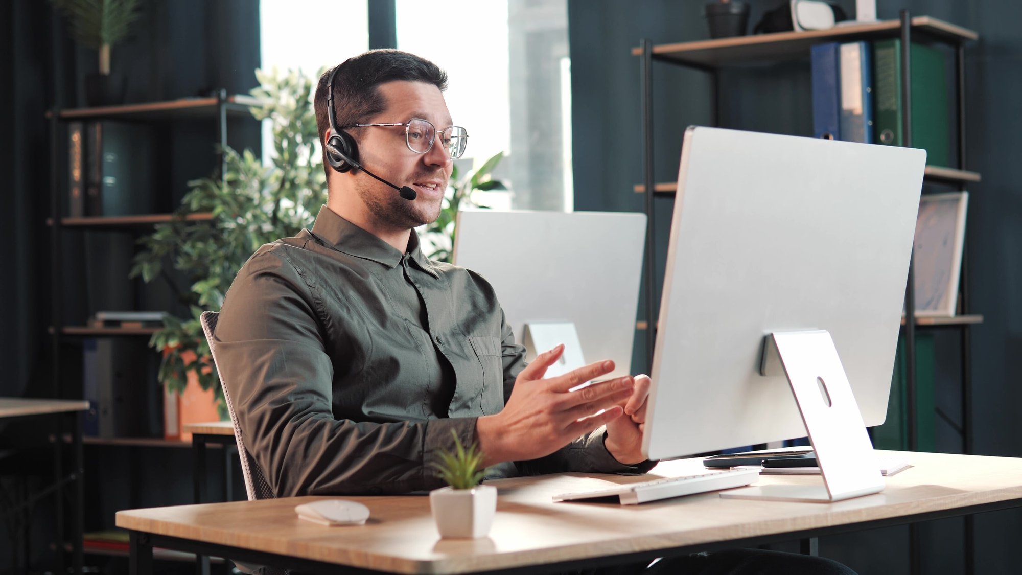 NIM_lead-fishing_positive-man-in-headphones-eyeglasses-communicates