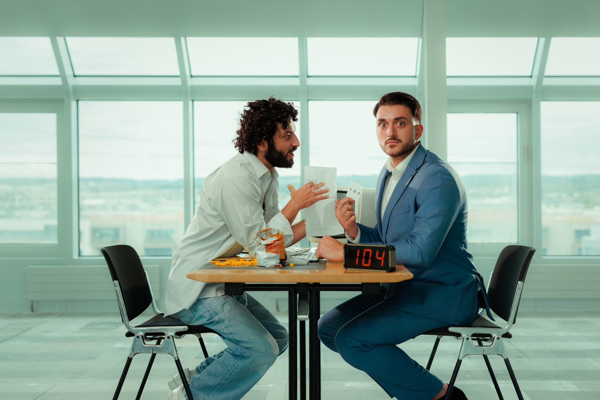 NIM-landingpage-misrouted-men-sitting-on-table